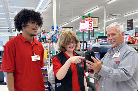 Weis Markets new graduates checking a POS at a store.
