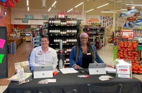 Weis Markets team members setting up a booth at a store.